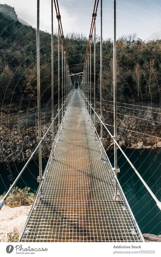 Suspension bridge in mountain gorge suspension rock pedestrian hang range river rough nature landscape breathtaking montsec empty way travel tourism journey