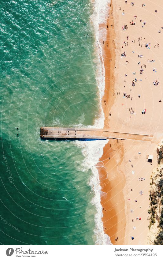 Aerial view of pier and beach in Albufeira, Portugal portugal albufeira aerial copy space landscape people tourists touristic algarve atlantic sunny yellow