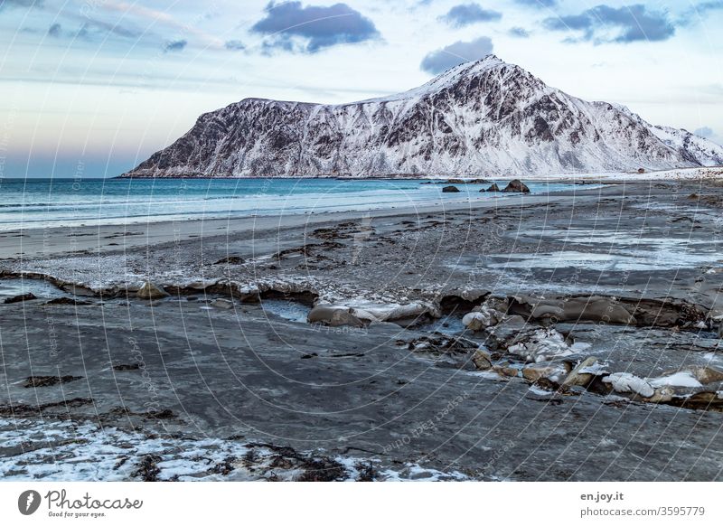 Beach in winter in front of snow-capped mountains Lofotes Norway Scandinavia Ocean Winter Mountain Snow Coast Vacation in Norway Travel photography Environment