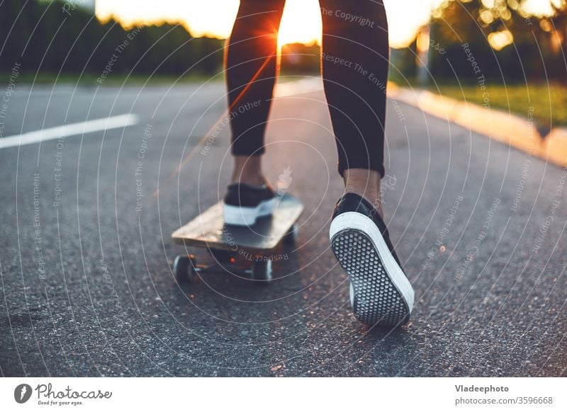 young skateboarder legs riding on skateboard girl shoes sneakers one woman female extreme youth yellow sunshine sports skateboarding usa vintage japanese