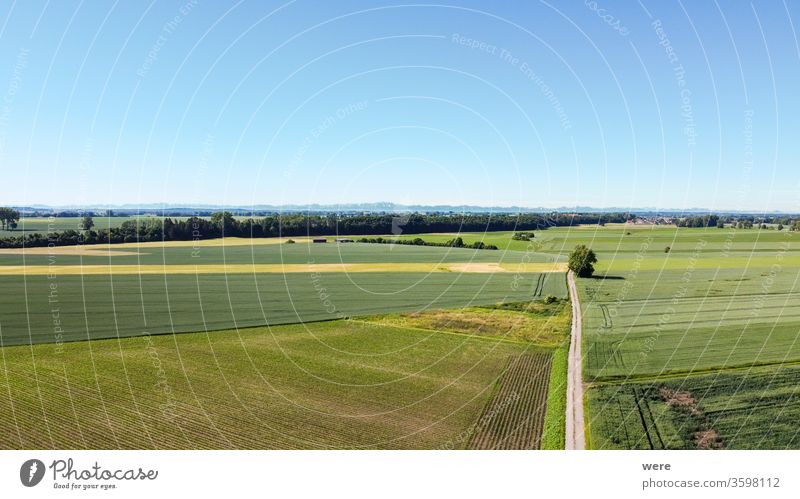 View from the air over agricultural land towards the Alps Area flight aerial view agricultural area agricultural fields alps bird's eye view copy space