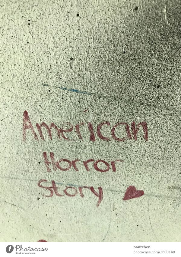 American Horror Story is written in red on a house wall. Politics, USA, crisis. Movie title. Trump American Horror story policy Crisis trump world affairs