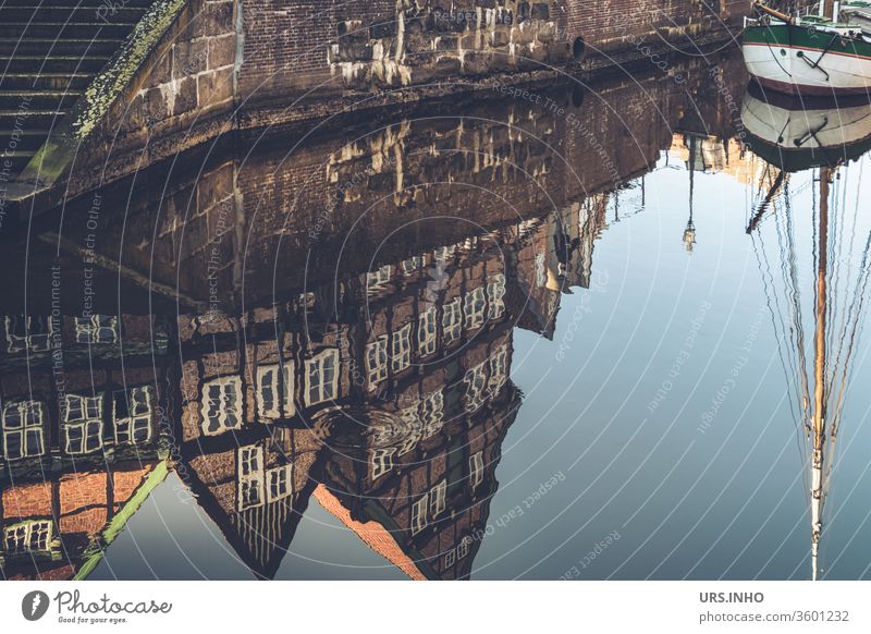 The old half-timbered houses and the mast of the sailing ship are reflected in the water Old town reflection Reflection Town Day quay wall Sailing ship Ewer