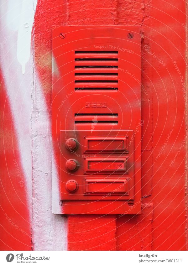 Bell plate with three bells and intercom system completely sprayed red Red Graffiti Exterior shot Name plate Intercom system White Colour photo Wall (building)