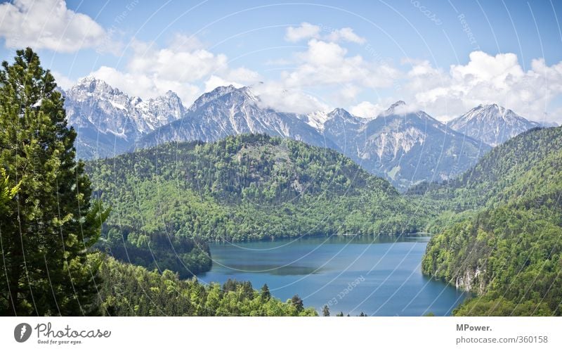 alpine lake Environment Nature Landscape Water Sky Clouds Sun Sunlight Lakeside Fjord Pond Blue Green Alps Pre-alpes Mountain Snowcapped peak Forest Bavaria