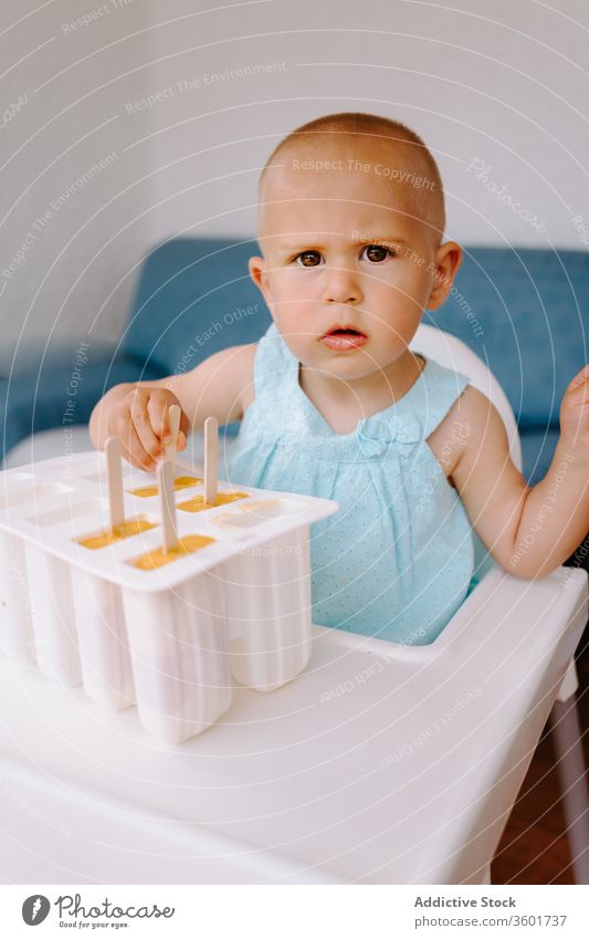 Adorable girl with mold of homemade ice lollies eat popsicle toddler ice cream summer adorable delicious treat terrace kid little child childhood relax carefree