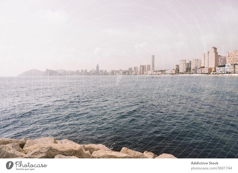 Modern coastal city with skyscrapers skyline embankment sea contemporary architecture cityscape waterfront spain benidorm haze cloudy urban travel tourism