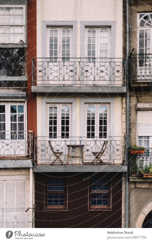 Shabby facade of residential building in city exterior chair aged house weathered shabby architecture background texture porto portugal construction old metal