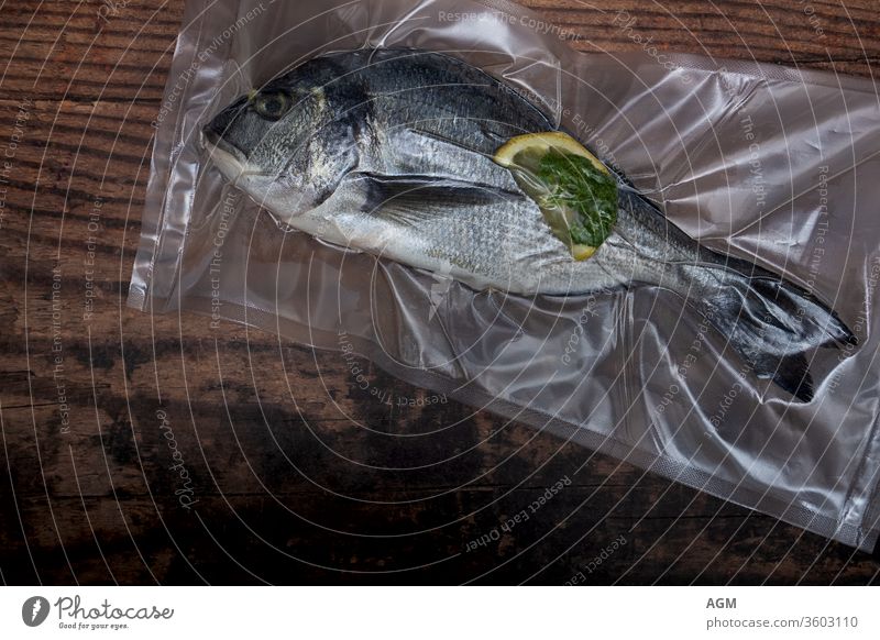 Dorade vacuumed for sous vide Food airtight bag clean eating cooking copy-space diet dorado fish flat lay fresh fresh fish garlic gourmet healthy home made