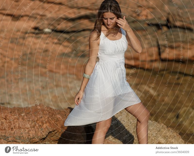 Tender woman in white dress at seashore in summer vacation tender beach seascape holiday enjoy female serene turquoise water sunny weather ocean relax tranquil