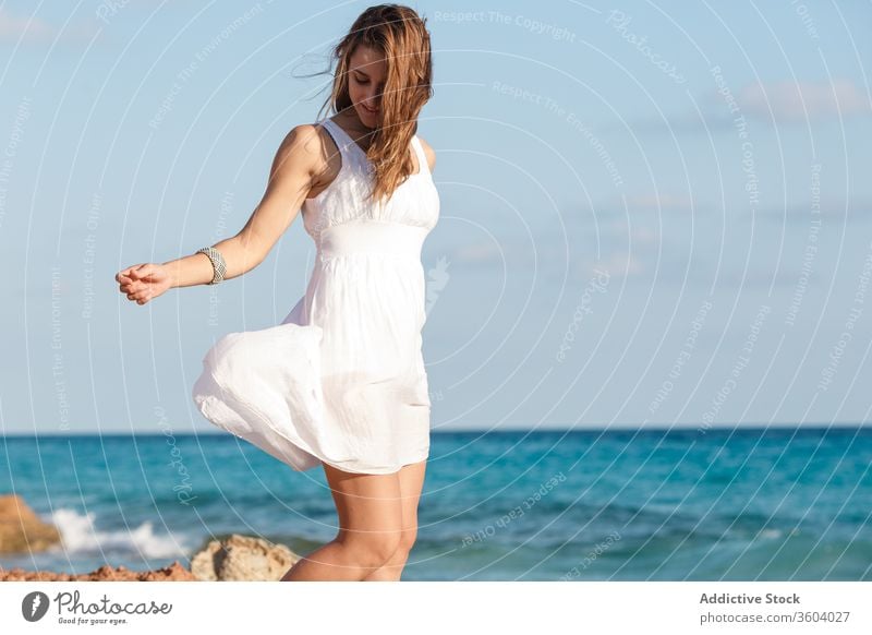 Tender woman in white dress at seashore in summer vacation tender beach seascape holiday enjoy female serene turquoise water sunny weather ocean relax tranquil