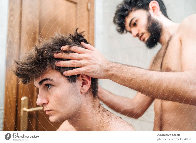 Crop barber doing haircut for man trimmer bathroom men grooming together hairdresser contemporary modern tool hygiene care routine beauty friendship hairstyle