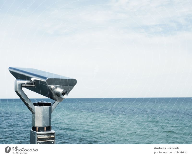 Binoculars on a pier, concept for far-sightedness or look into the future vision farsightedness city background european shore binoculars business famous