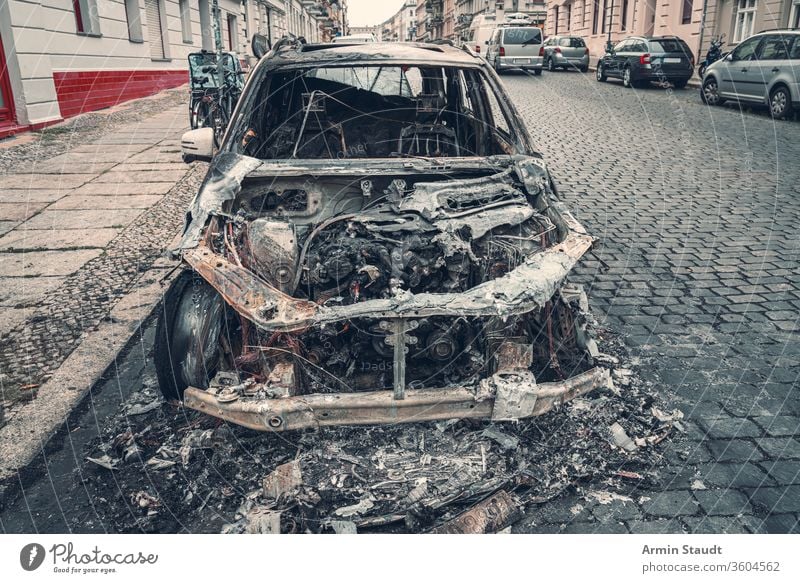 burnt out car in the streets of berlin accident attack background blaze broken burned burning city crime damage danger dangerous destroyed destruction emergency