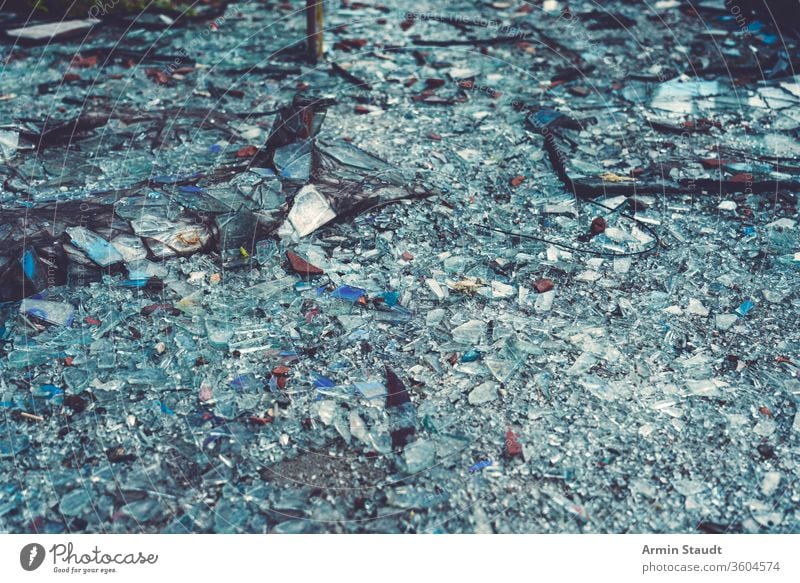 close up of colorful glass shards covering the ground cracked crushed damage abstract accident background break broken crash debris destruction dust earth