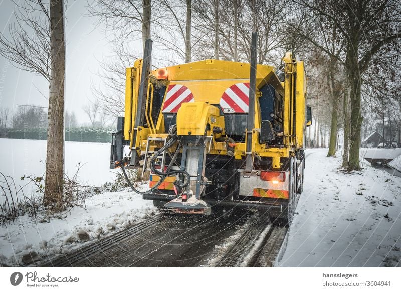 Winter service truck spreading salt on road snowplow plowing blizzard winter clean snowfall cold clear icy removal storm tractor snowstorm vehicle equipment