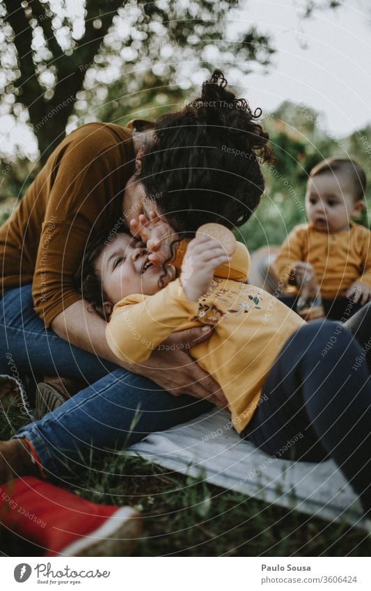 Mother with two childs Kissing kiss Love Together togetherness Hapiness young woman love caucasian hug happy Lovers friends care people Nature lifestyle female