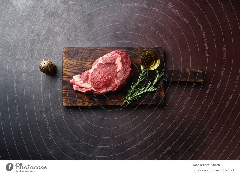 Raw beef meat on table black angus steak beefsteak flat lay barbecue food cooking raw cut ribeye marbled rib eye uncooked gourmet surface filet top view chop