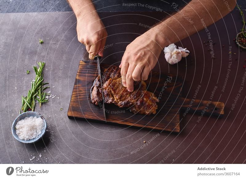 Hands cutting beef steak ribeye grilled black angus food meat cuisine hands beefsteak roasted tasty sliced closeup salt cooking filet protein fresh healthy