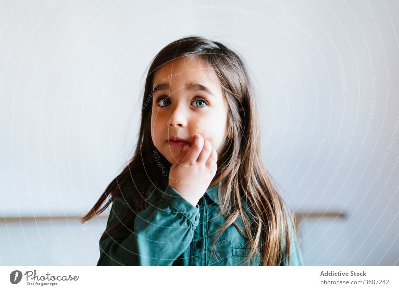 Adorable girl with blue eyes on white background kid cozy beautiful relax cute adorable child chill comfort home carefree pretty content glad touching face