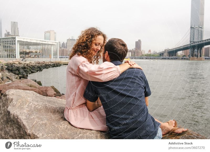 Tender couple kissing on river bank in New York relationship together romantic hug brooklyn bridge tender stroll new york america united states usa city love