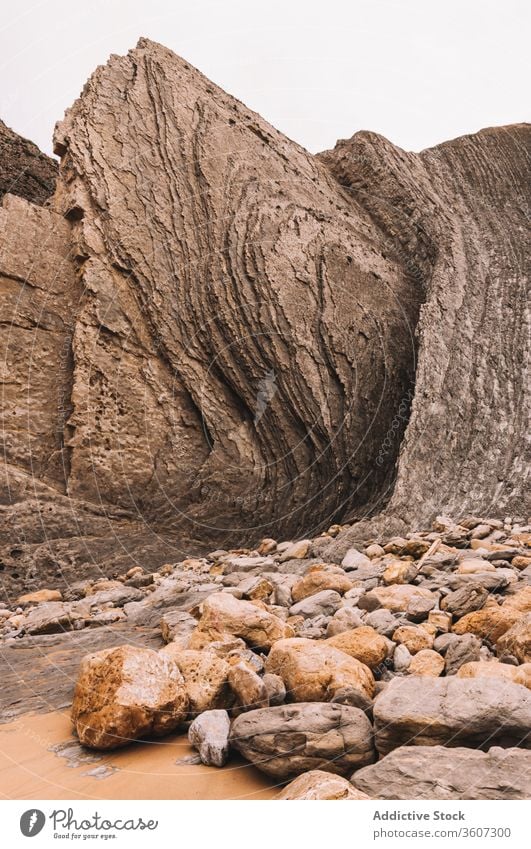 Rough rocky formations with creek cliff stone geology nature landscape cleft cave rough boulder scenery environment mountain wild mineral stream flow water