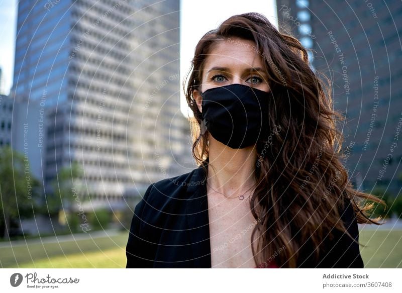 Serious woman in medical mask in city epidemic coronavirus covid 19 protect prevent safety female downtown serious modern respirator pandemic outbreak stand