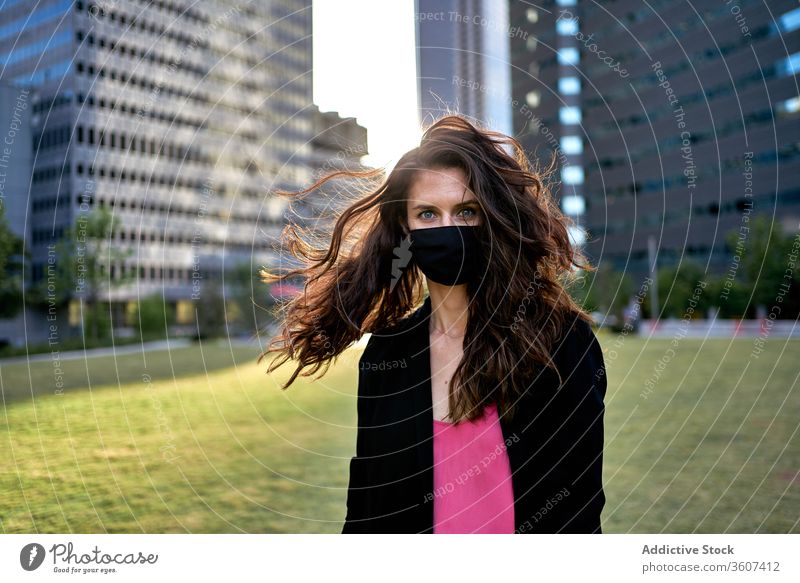 Serious woman in medical mask in city epidemic coronavirus covid 19 protect prevent safety female downtown serious modern respirator pandemic outbreak stand