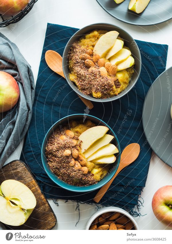 Cozy Breakfast food concept with turmeric amaranth breakfast morning plant based food bowl cozy apples golden almond recipe still life flat lay porridge served