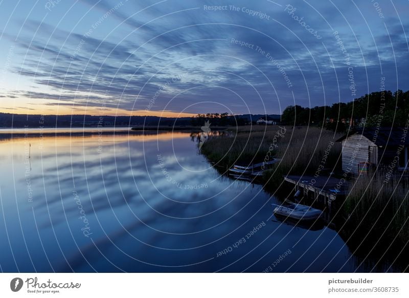 Blue hour at the lake blue hour Lake Ocean Clouds Sky Sky blue reflection Water bank silent Sunset boat hut Footbridge relaxation Summer Loneliness good weather