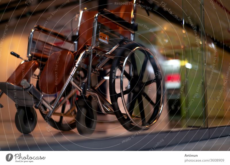 Blurred empty wheelchair near lift in private hospital for service patient and disabled people. Medical equipment in hospital for assistance handicapped people. Chair with wheels for patient care.