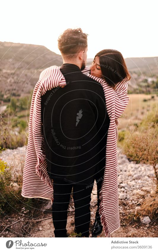 Gentle couple embracing on hill during vacation hug valley admire mountain together spectacular scenery girlfriend boyfriend plaid relationship nature love