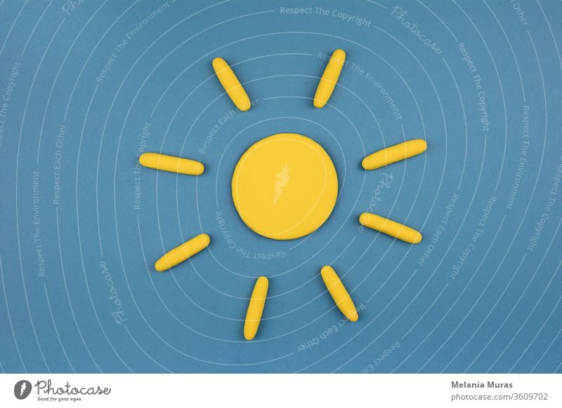 Sun symbol on blue sky background. Sunny weather concept. Summer mood. blue background bright circle climate copy space design disc dry element energy flat lay