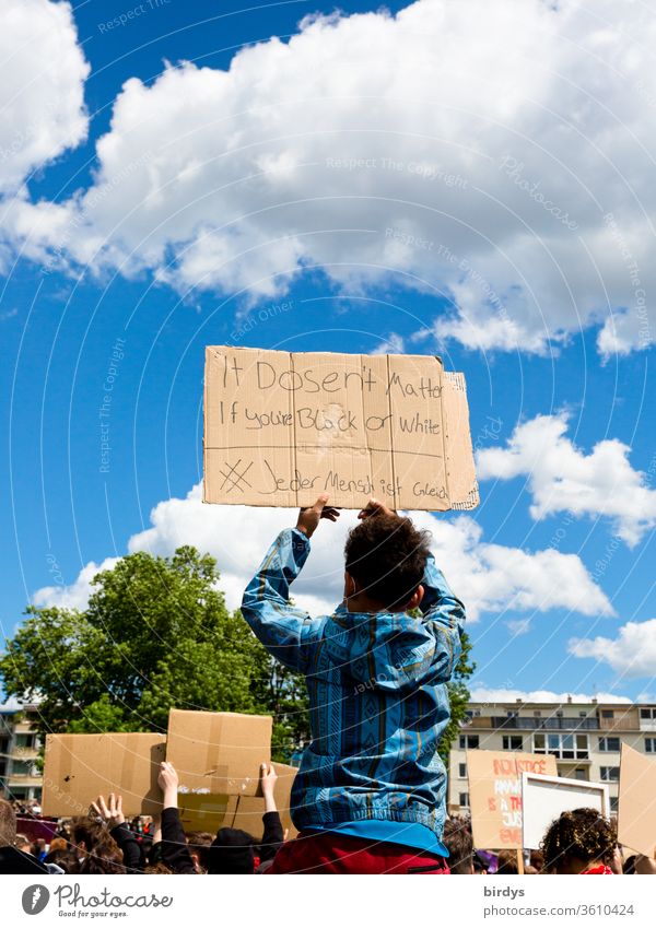 Whether black or white, all people are equal.black lives matter - Demonstration in Cologne on 06.06.2020. BLM, blacklivesmatter, against racism and police violence.Colourful writing on a cardboard sign