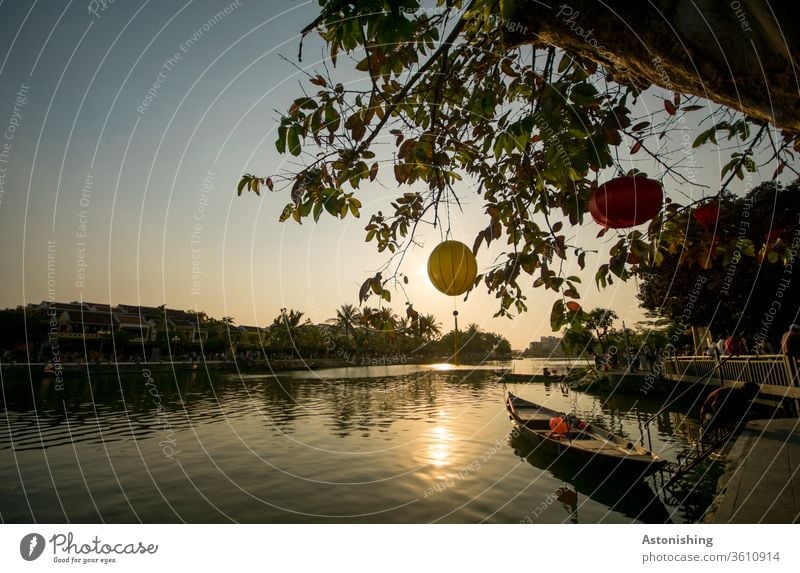 Evening light with lanterns at the river in Hoi An, Vietnam Lantern evening light Sun Sunlight boat River Rowboat tree leaves Sky Nature Twilight Thu Bon Water