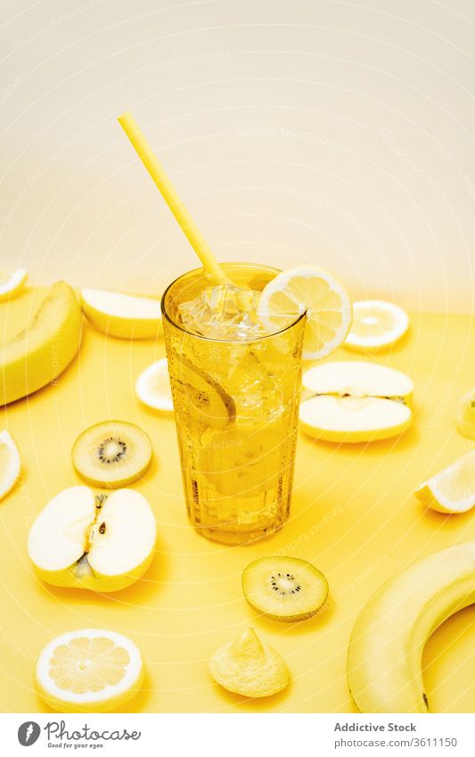 Refreshing fruits and cocktail on yellow background refreshment color vibrant vivid beverage creative healthy food glass arrangement various composition drink