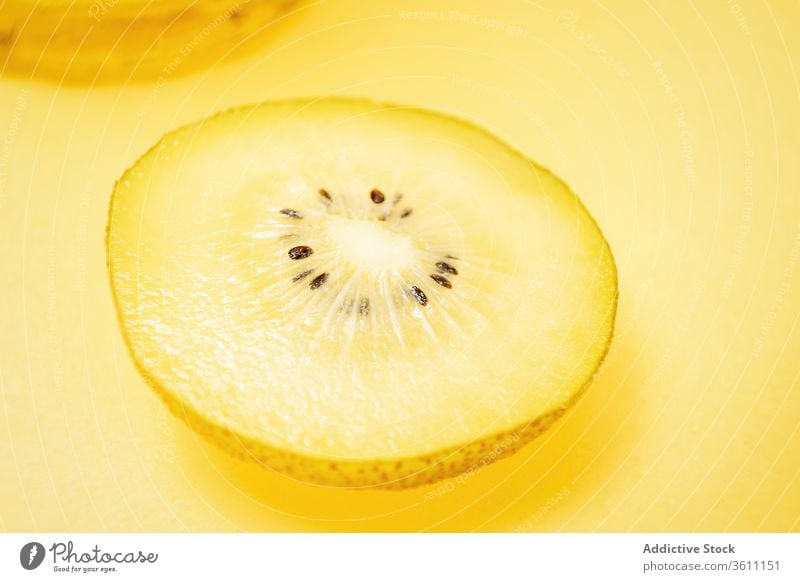 Kiwi sliced on yellow background kiwi color fruit vibrant vivid creative healthy food fresh arrangement composition vitamin organic summer mix natural tasty