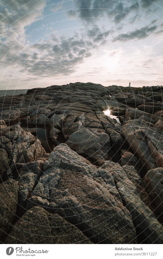 Sunset sky over cove and stony shore sea sunset cloudy water stone peggys cove canada rock coast sundown evening twilight dusk ocean weather nature idyllic