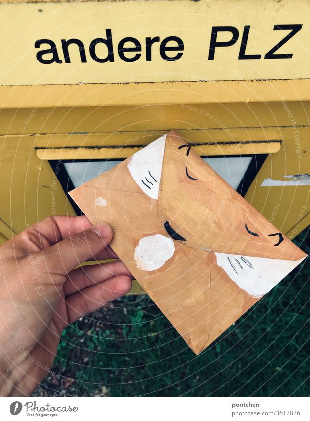 Hand throws an envelope painted as a fox into the letter slot for other postcodes in the mailbox. Invitation to a child's birthday party Mailbox Lettering