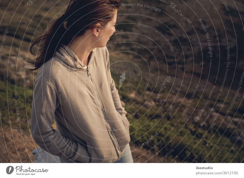 Enjoying the nature woman mountain travel landscape relax contemplate rest adventure rock sunset chill sit girl meditate top summer looking sunrise view