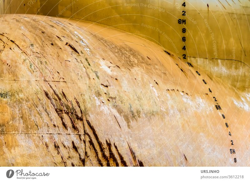 yellow bow of a ship with rust and draught marks | large ship nose as background Yellow Rust Draft Brands Sign Numbers bulge Bead bend Nose Ship's nose Detail