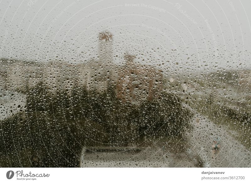 Wet window against the background of an evening view of the city raindrop water abstract wet texture nature glass weather rainy aqua urban liquid reflection