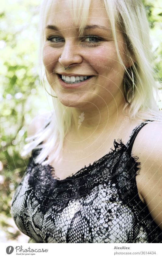 Portrait of a young blonde woman in a sunny forest girl Young woman already smile Blonde long hairs blue eyes youthful 19 18-20 years 15-20 years old portrait