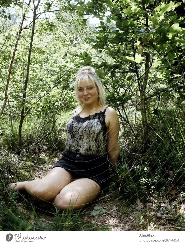 Portrait of a young blonde woman in a sunny forest girl Young woman already smile Blonde long hairs blue eyes youthful 19 18-20 years 15-20 years old portrait