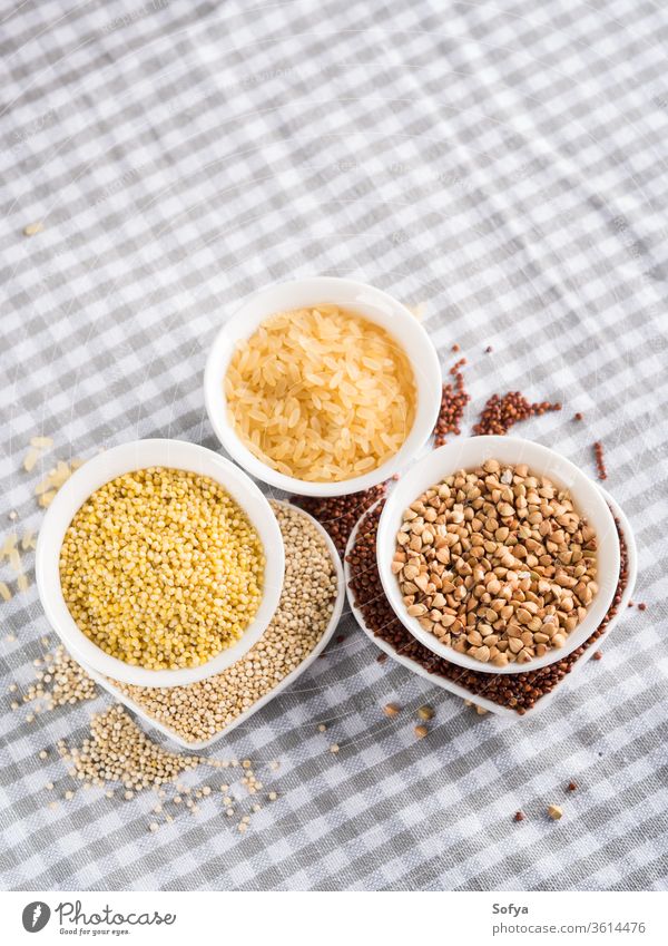 Gluten free grains in bowls on kitchen table gluten quinoa rice buckwheat amaranth millet mix celiac diet food ingredient uncooked white health whole cloth