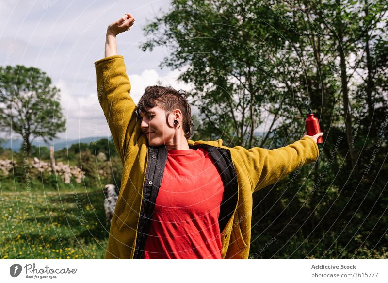 Carefree woman enjoying summer during vacation traveler meadow freedom carefree content tourism landscape nature informal female asturias spain rest relax