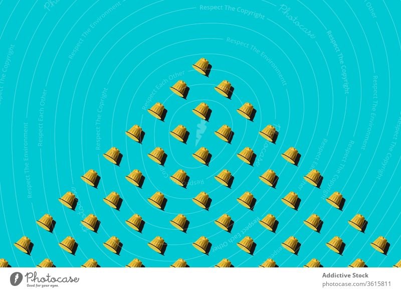 Pattern of coffee capsules on blue background pattern seamless pod row even delicious repeat aroma composition fresh arrangement color vibrant vivid bright