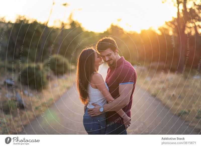 Loving couple embracing in park tender embrace sunny together love happy smile relationship romantic garden hug affection summer date close romance enjoy