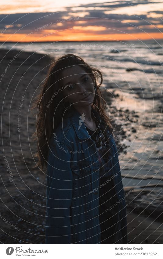 Tranquil woman at seaside in evening hippie beach sunset calm tranquil travel female ocean summer relax coast vacation water peaceful shore scenic nature