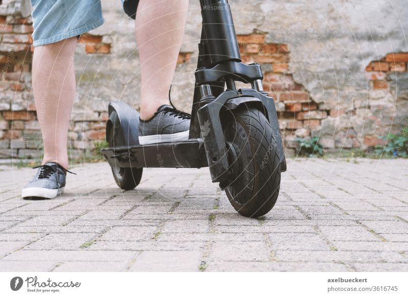 Legs of an unrecognizable man with electric scooter e-roller Scooter eMobility Micro mobility Lifestyle Hip & trendy escooter Transport Electric person feet